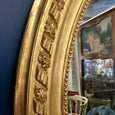 Miroir oval en bois et stuc doré style Louis XVI