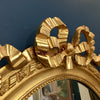 Miroir oval en bois et stuc doré style Louis XVI